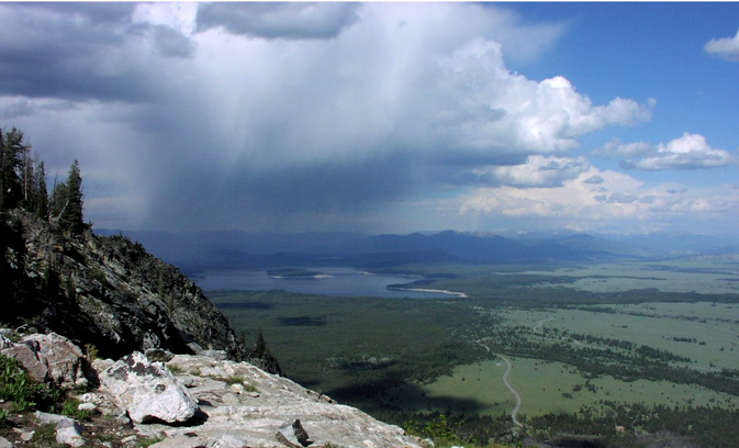 rain falling onto lake from huge cloud