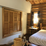 bedroom with wood screen in wall