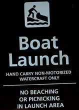 sign says no beaching or picniking in launch area