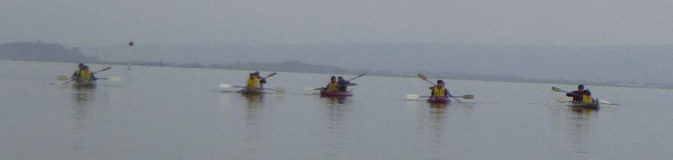 kayaks in a row to start a race