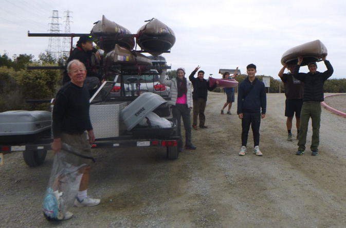 people and boats around trailer