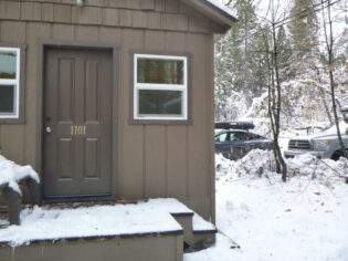 cabin with parking area next to it