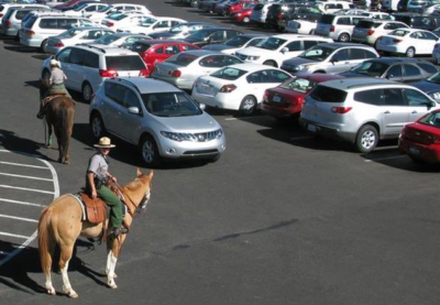 Rangers on horseback in parking lot