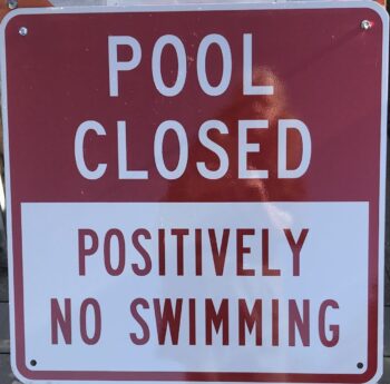 sign says pool closed positively no swimming