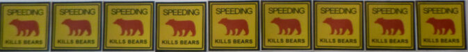 row of stickers that say speeding kills bears