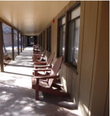 hallway outside of Yosemite Lodge Cedar building no patios just a row of chairs