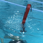 rescue tube partially in air at pool surface