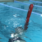 rescue tube partially in air at pool surface