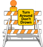 sign on road barrier in drawing says turn around don't drown