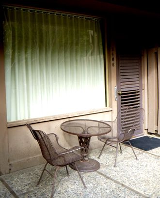 2 chairs and a table on a patio