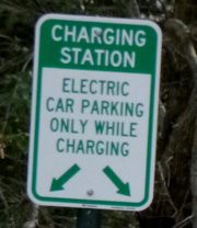 sign says charging station electric car parking only while charging