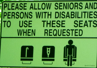 sign says please allow seniors and persons with disabilities to use there seats when requested