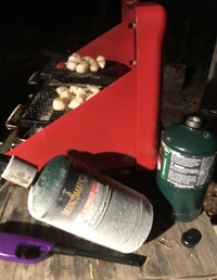 camp stove and propane canister with frost on it