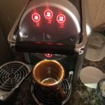 four red lights on front of coffee maker