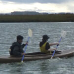 2 adults paddling a kayak