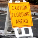 sign says caution flooding ahead