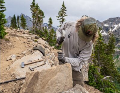 man chiseling a rock