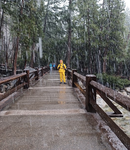 man on bridge in heavy precipitation