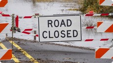 sign on barrier says road closed