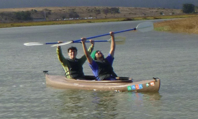 paddlers raise their paddles up