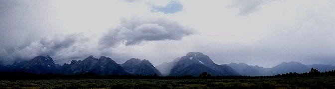 mountain range with a few clouds