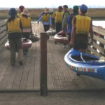 carrying kayaks down a ramp