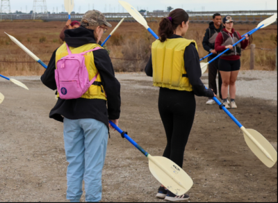 kayaking partners practice using their paddles in tandem