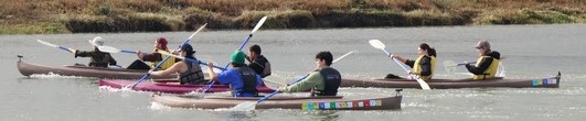 people racing in tandem kayaks