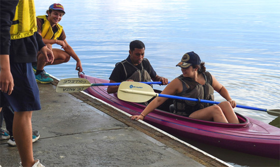 people launching a kayak