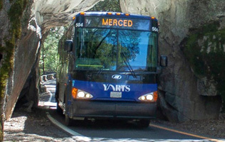 bus going between rocks as tall as the bus