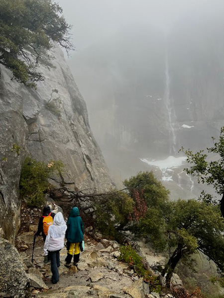 people on trail looking toward upper yosemite fall