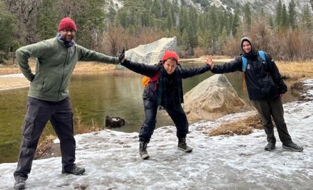 three people pose for photo