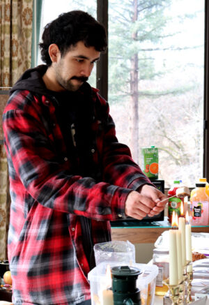 man roasting a marshmallow over a dinner candle