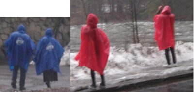 four people wearing rain ponchos
