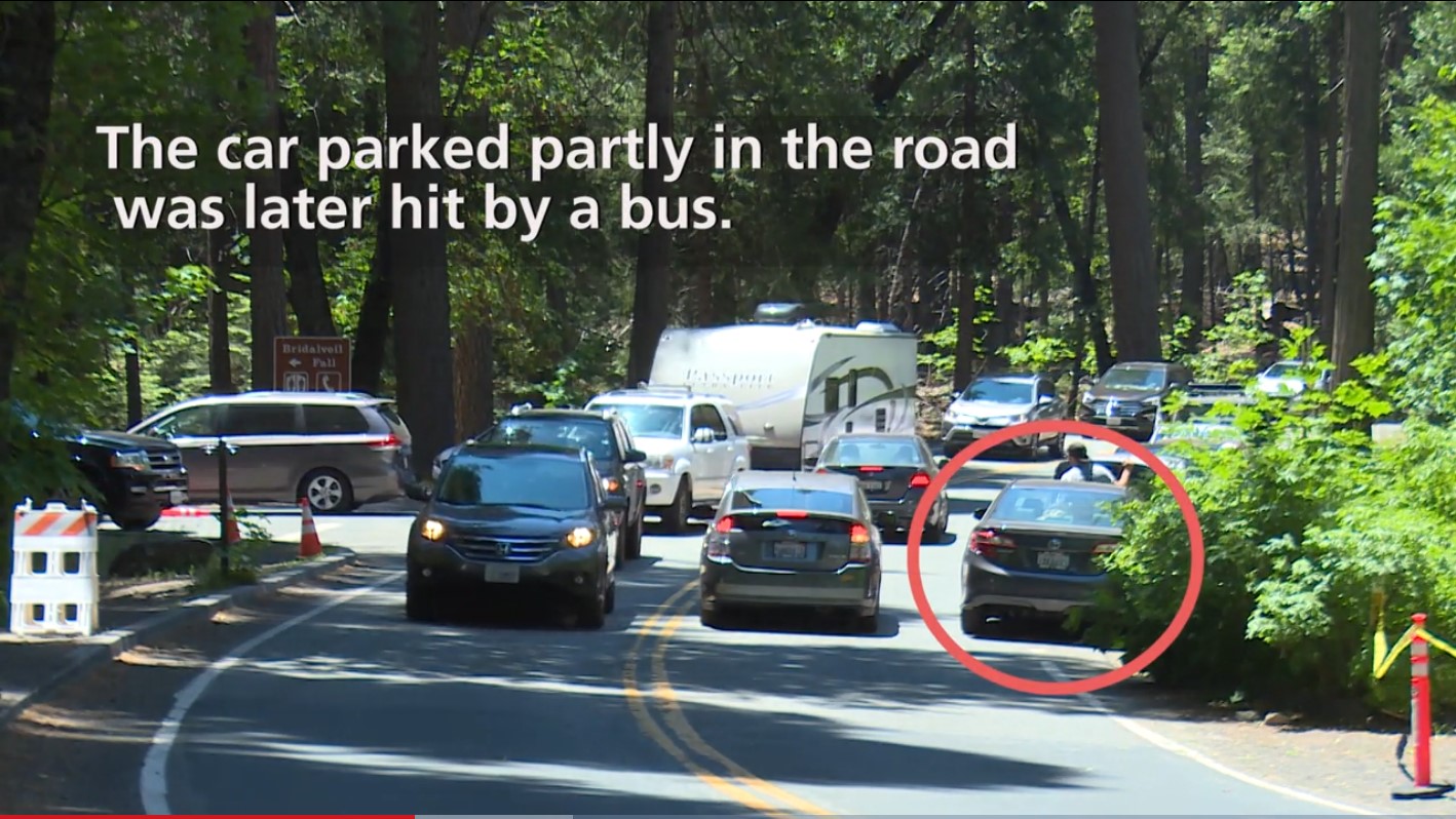 car parked partially in road