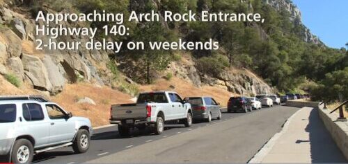 photo says approaching arch rock entrance station, highway 140 2 hour delay on weekends