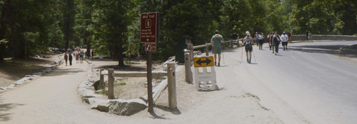 people on either side of road over bridge