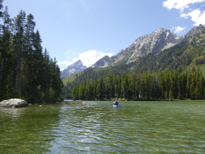 paddler with mountains beyond