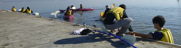 people getting into a kayak at a dock