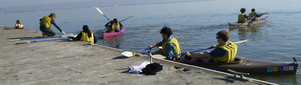 people launching kayaks from dock