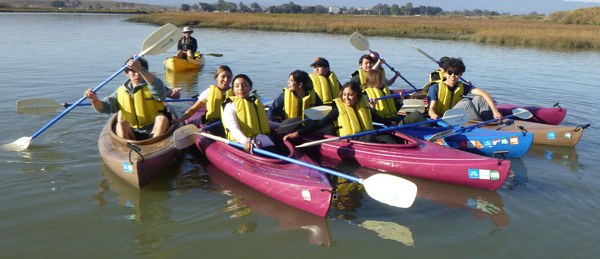people in kayaks in a group photo