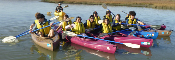 people in kayaks in a group photo