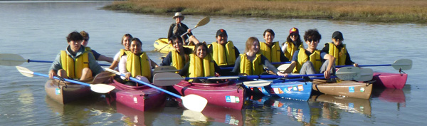 people in kayaks in a group photo