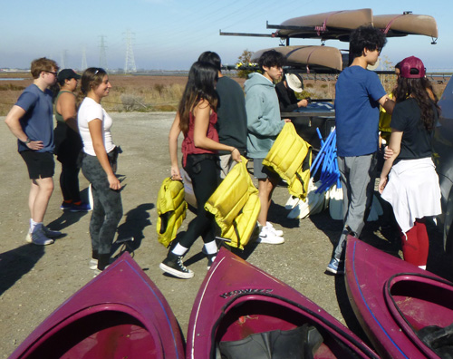 people with lifejackets standing in a line