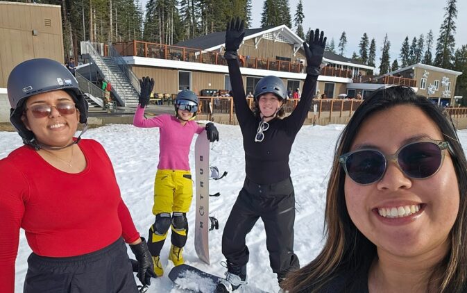 4 women with snowboards