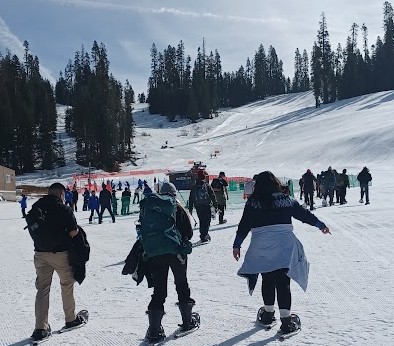 3 people walking on snowshoes