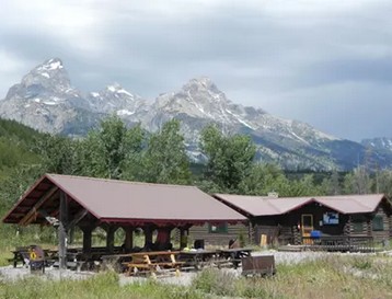 two buildings with mountain behind