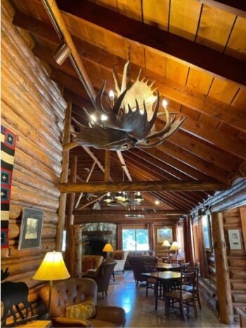 elaborate chandelier, hardwood floors and log walls at hotel