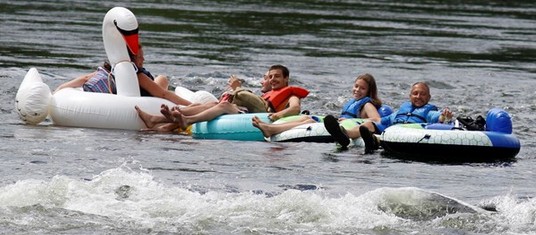 people on float tubes, one tube looks like a swan