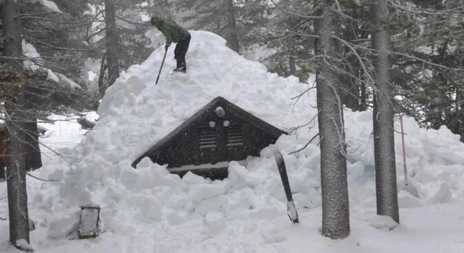 ranger on roof clearing snow